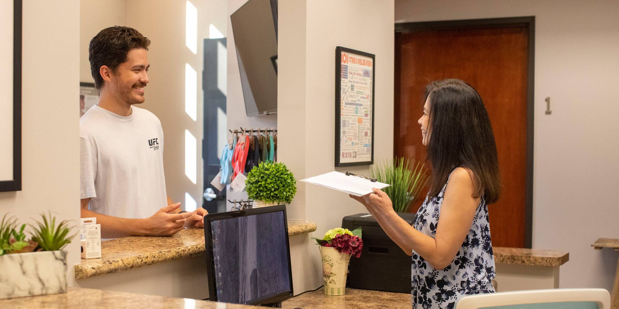 A patient being welcomed at Islands Chiropractic & Massage
